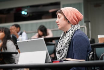 Jessa Lingel sitting at desk listening to lecture.