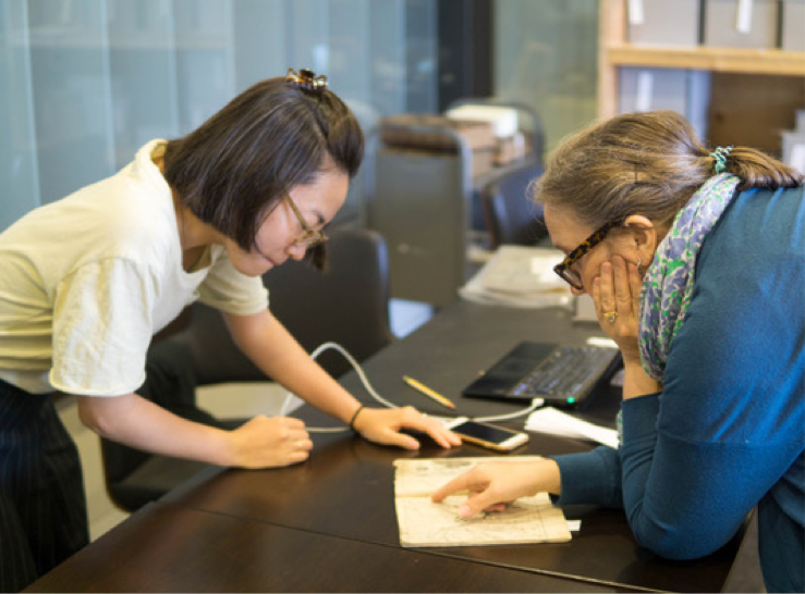 Professor Davis (right) and Naoko Adachi, doctoral candidate in East Asia Study at Penn, review a book from the Tress Collection.