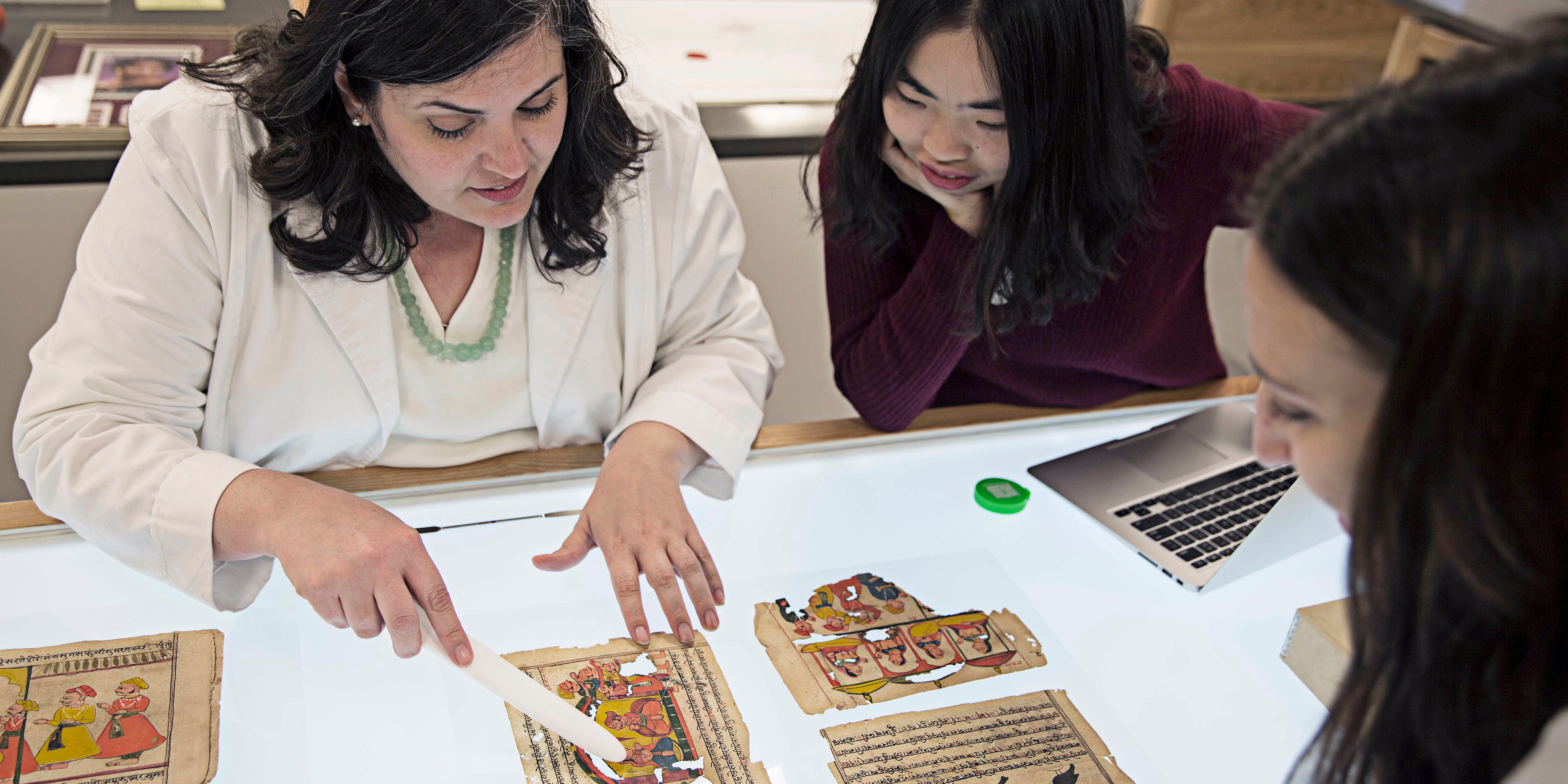 Students being shown torn page from book on light table