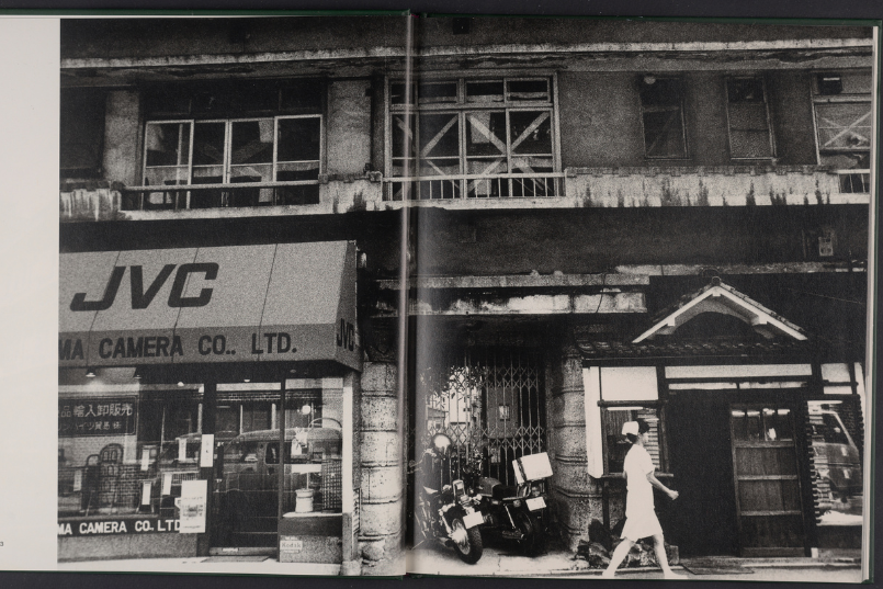 Black and white art photo of a busy street scene.