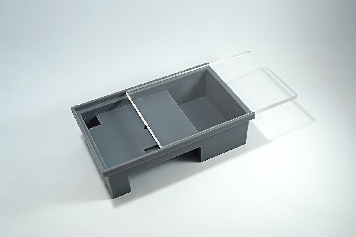 Plastic grey box with clear lid.