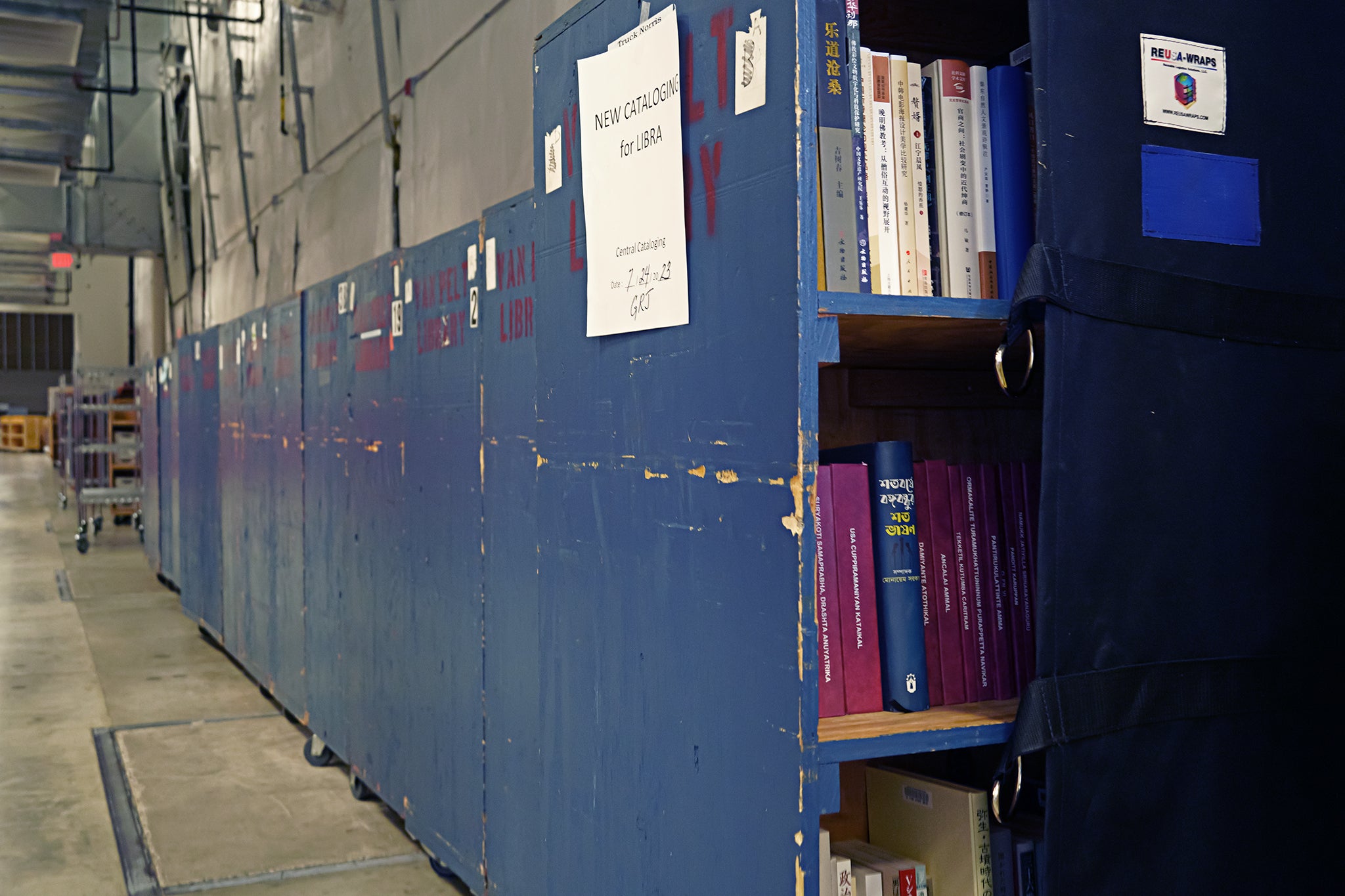 A long line of book crates stretches into the distance.