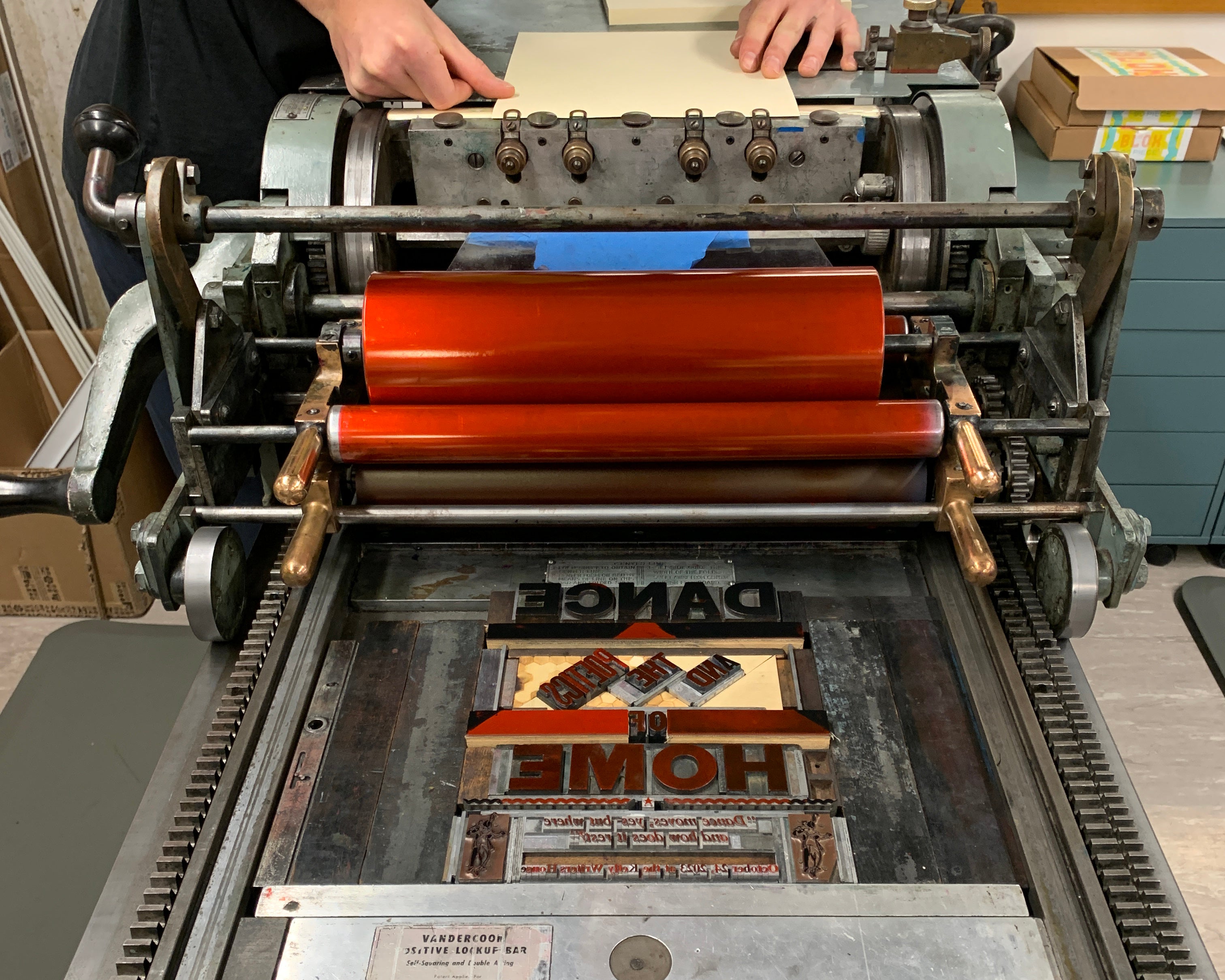 Movable type on a printing press with red ink