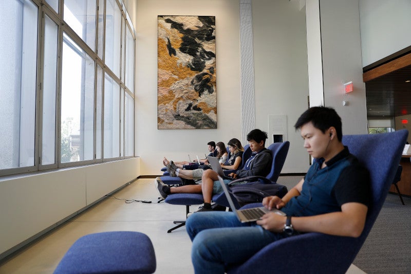 Students studying in Moelis Grand Reading Room