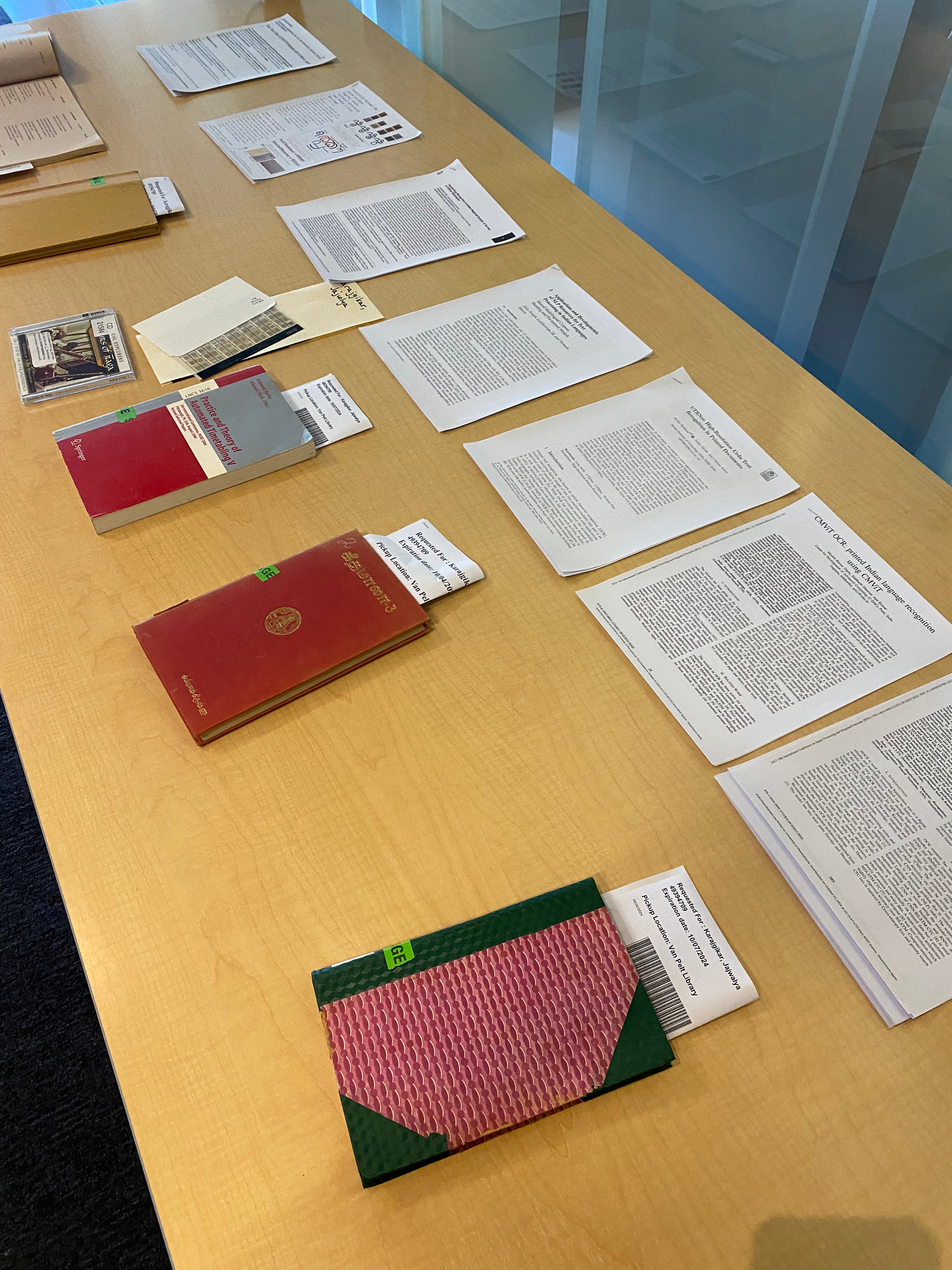 books and research papers on a yellow table