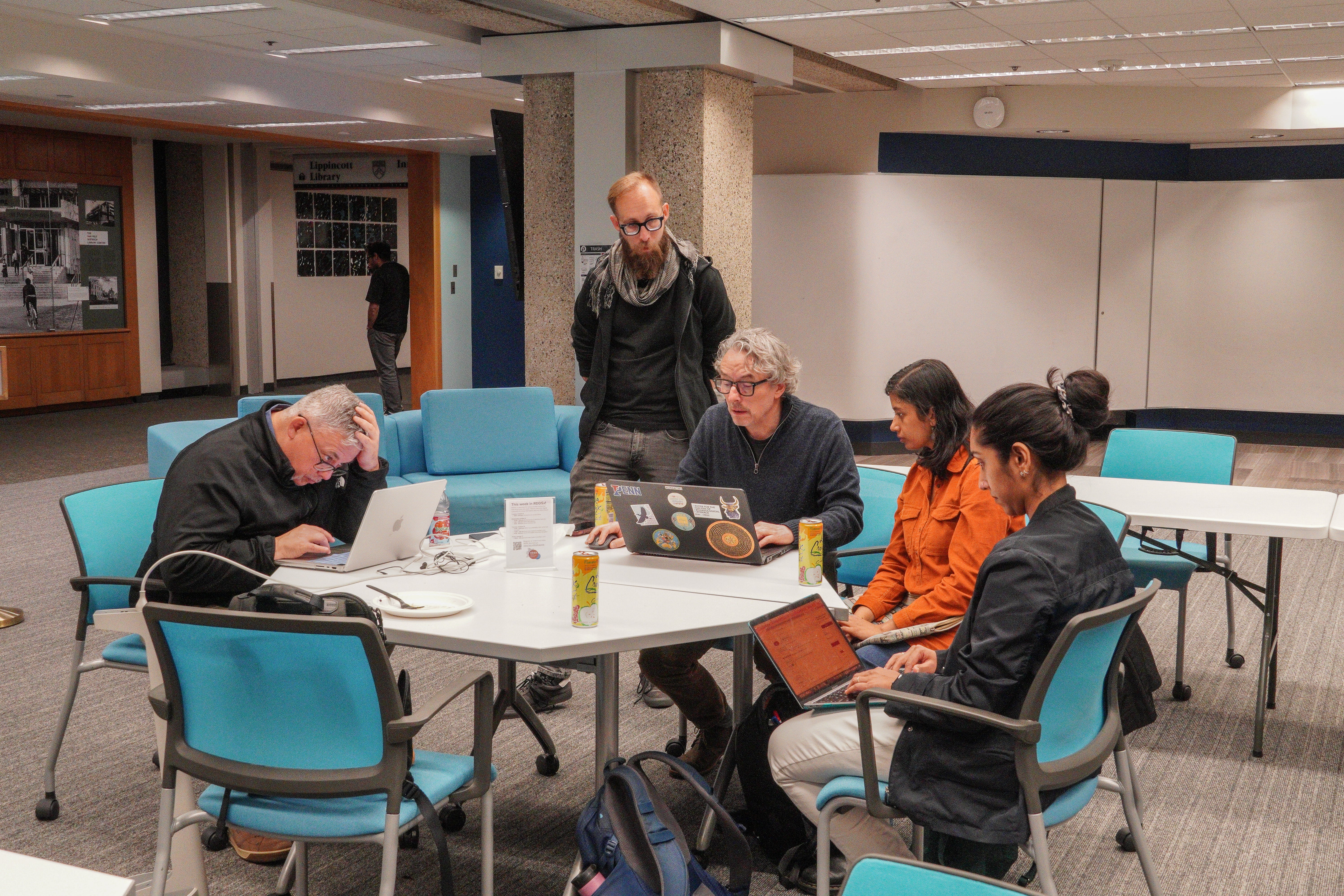 group of researchers around laptops