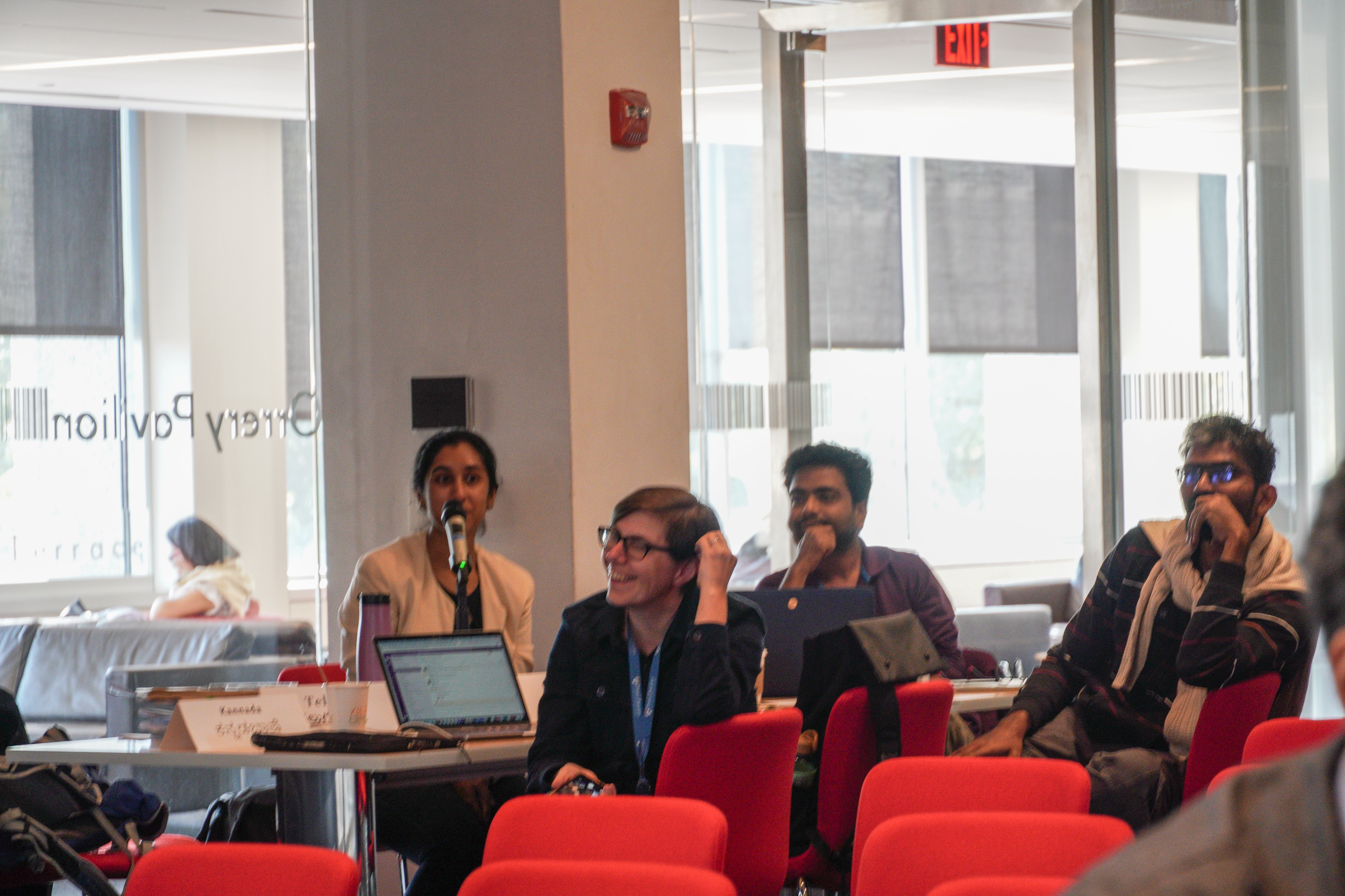 people at a table with laptops smiling