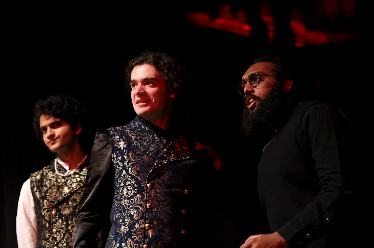 Three men performing on stage