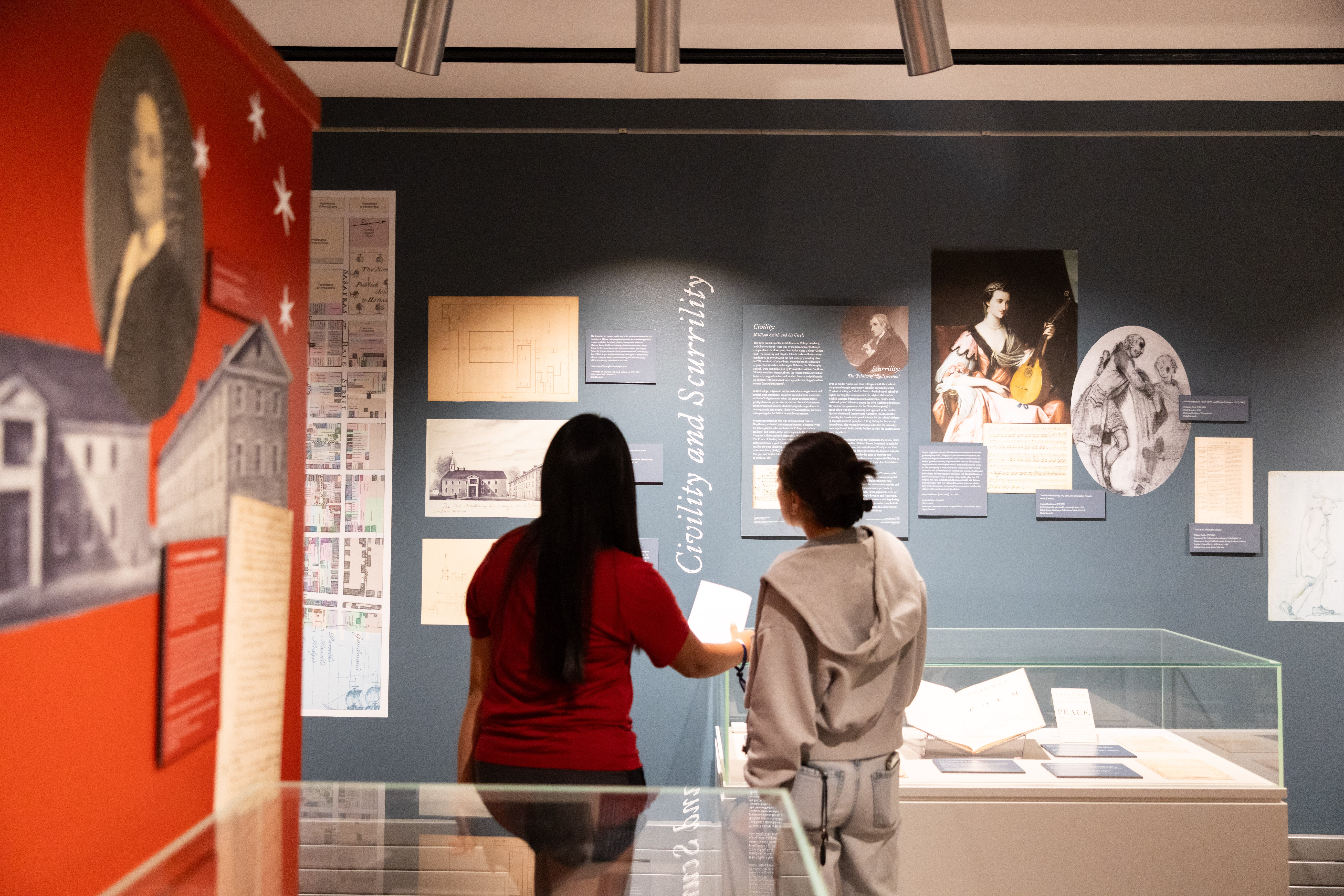 Two individuals view an exhibit display