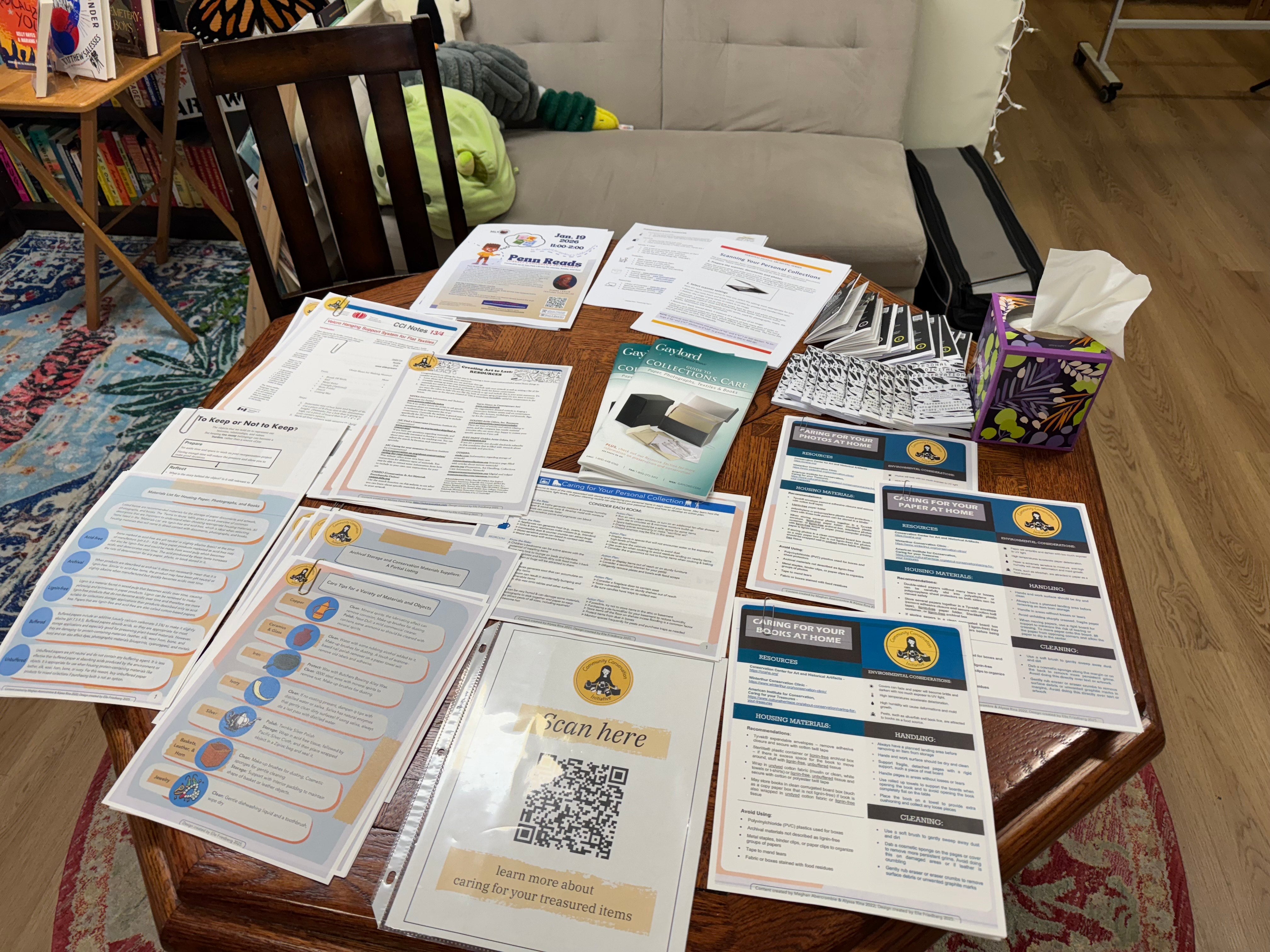 stacks of informational flyers about archival conservation sit on a table