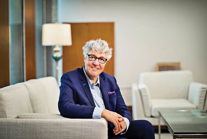 Portrait photograph of Constantia Constantinou sitting on couch