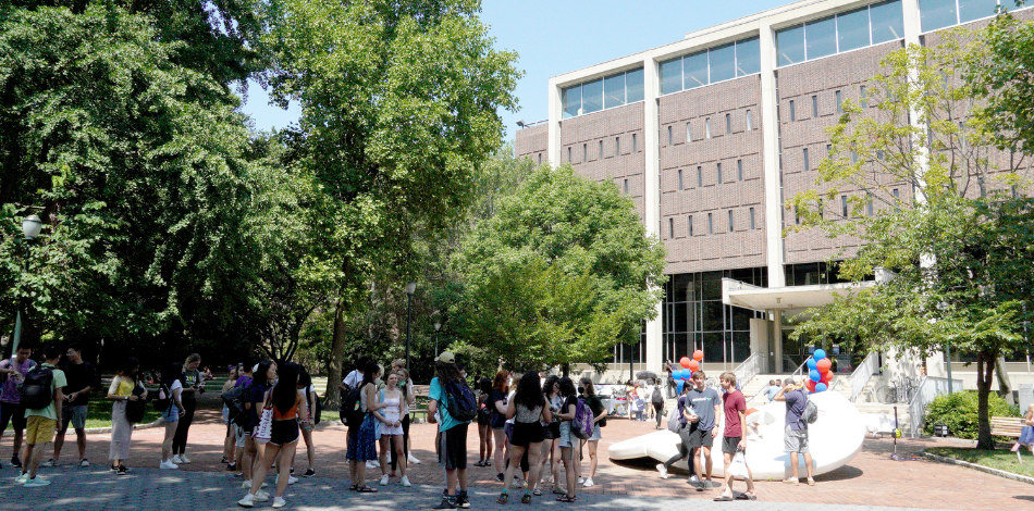 Students milling around outside the Van Pelt Library.