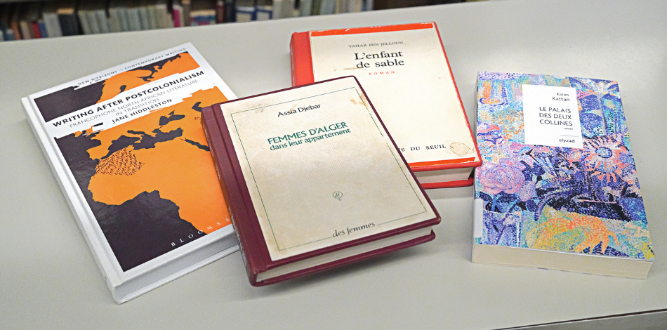 Four books sitting on a white table, all of them with titles in French.