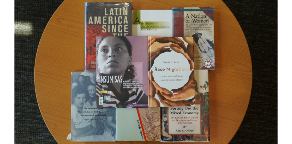 Several books related to Hispanic heritage, history, and culture laid out on a table. 