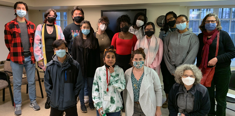 A group of students and staff standing together and smiling at the camera.