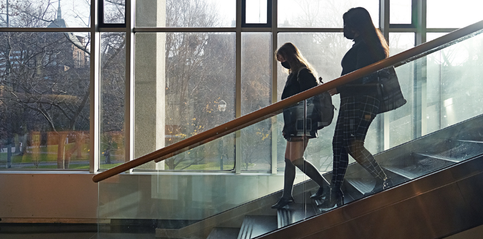 Two students walking downstairs.
