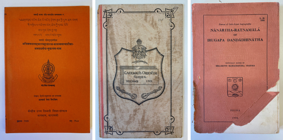 Three books with orange and grey covers with titles written in Sanskrit.
