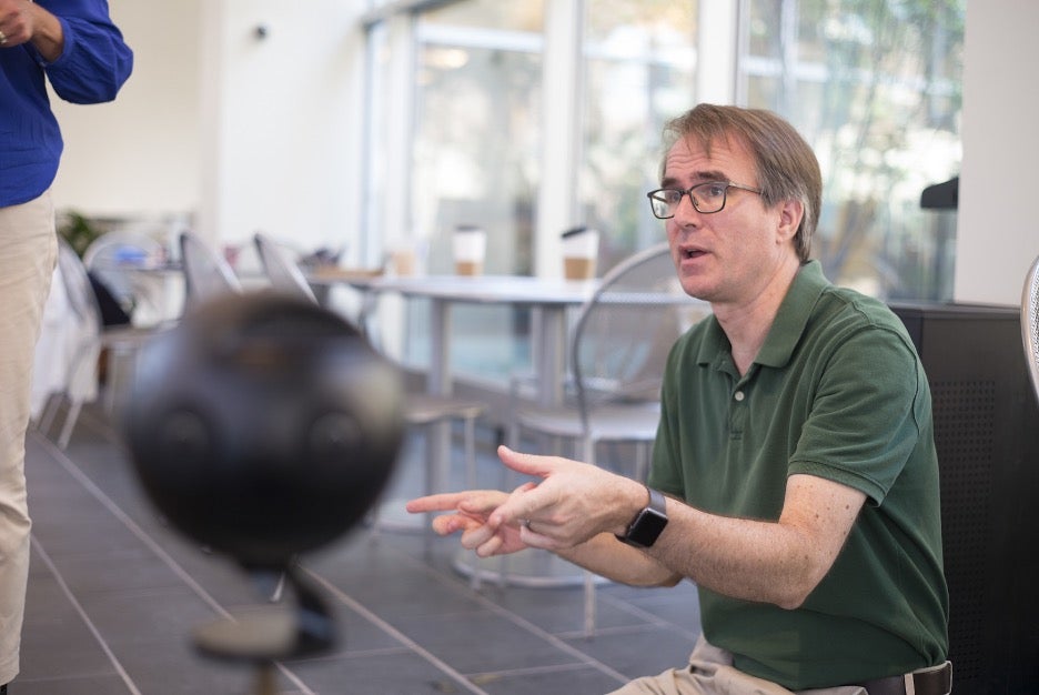 Man gesturing to VR camera.